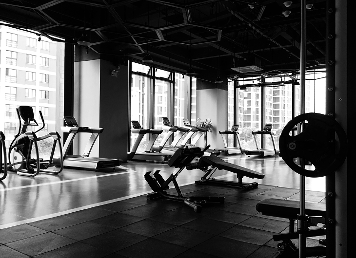 A gym with treadmills and weight training machines