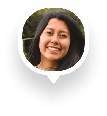 Smiling young woman with long dark hair outdoors, framed within a speech bubble shape.