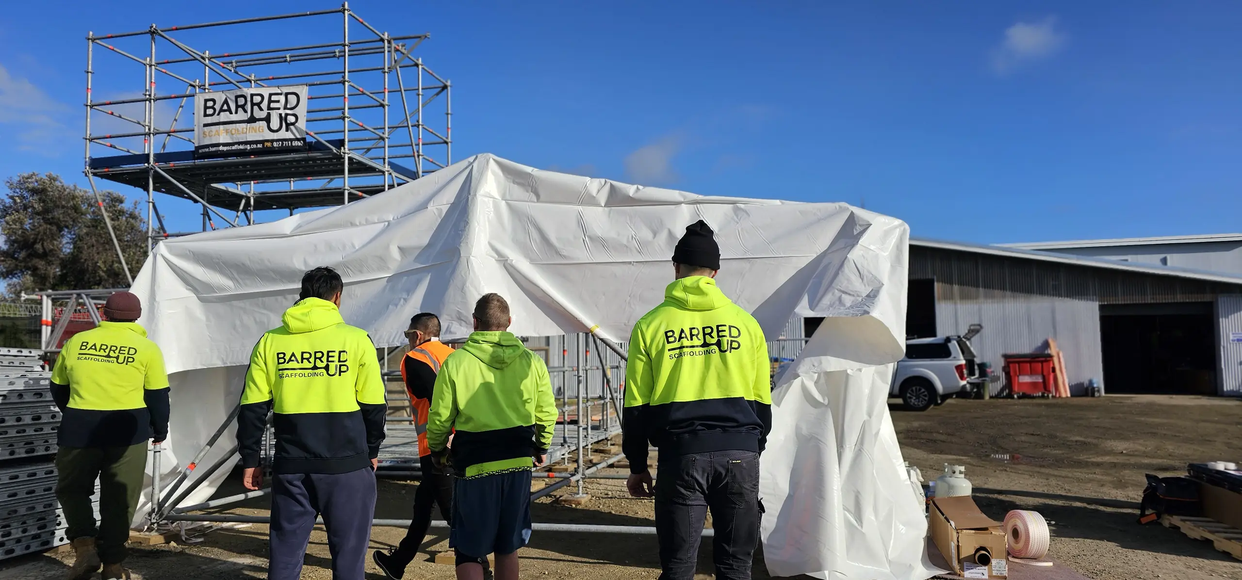Barred Up Scaffolding team setting up shrink wrapping enclosure