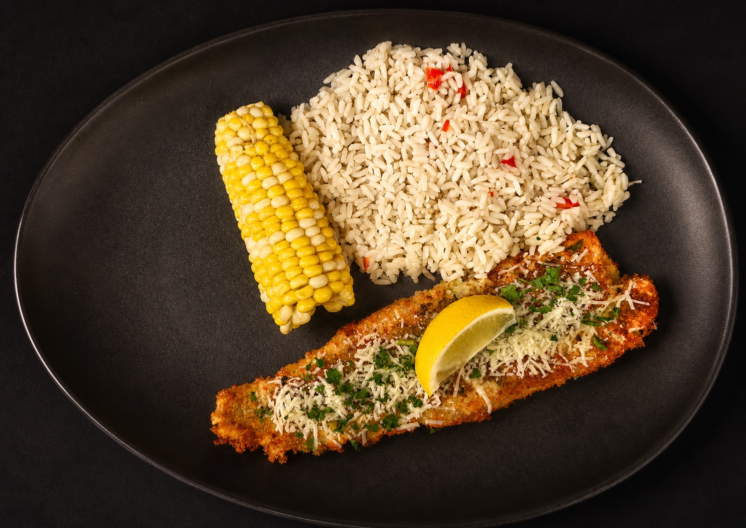 Parmesan crusted baked cod with rice pilaf and corn on the cob