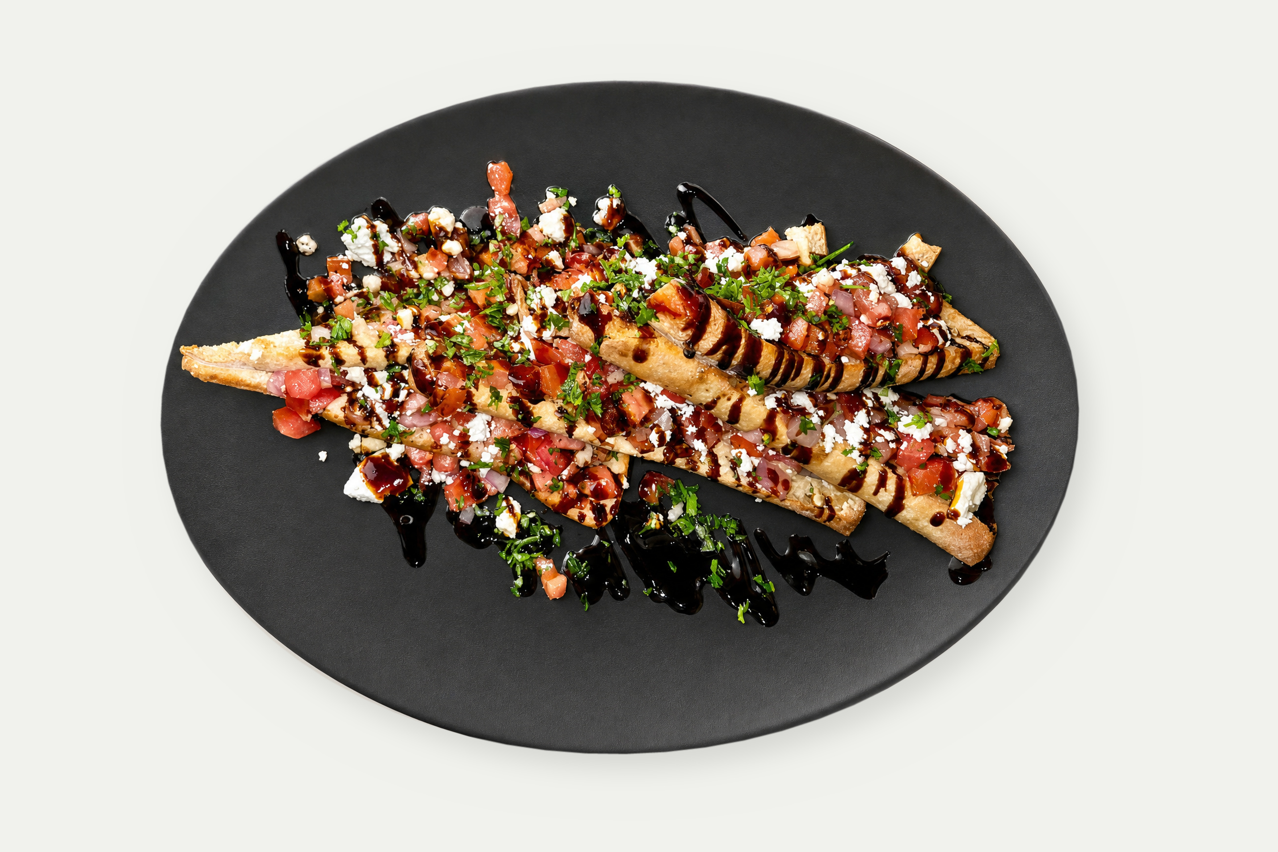 Feta bruschetta on grilled ciabatta with bruschetta salsa, feta cheese and balsamic drizzle