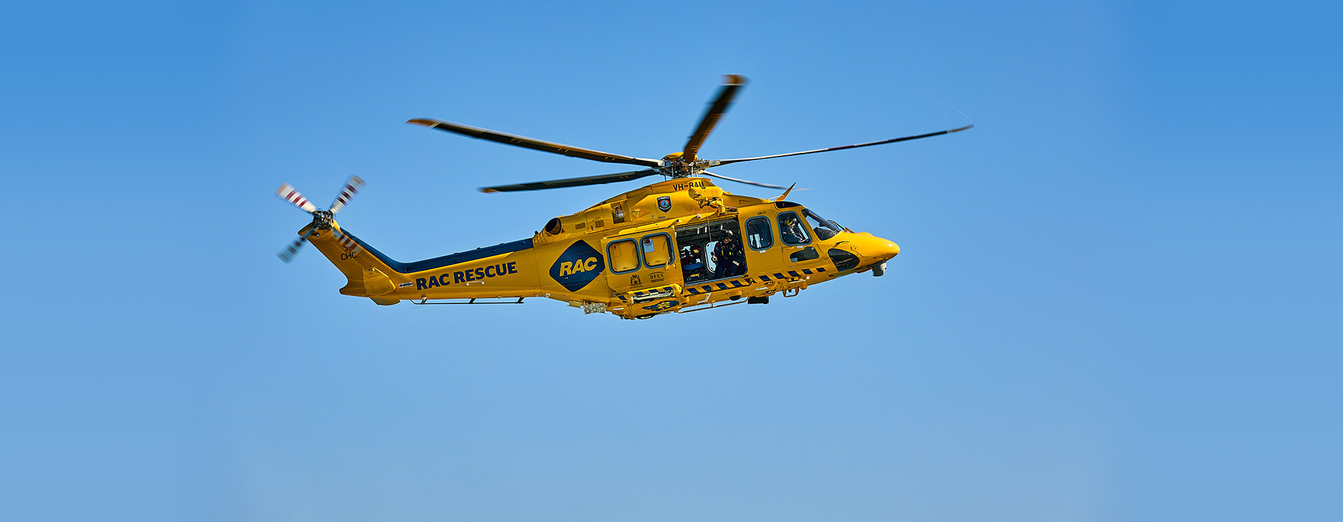 RAC Rescue Helicopter flying, surrounded by blue skies