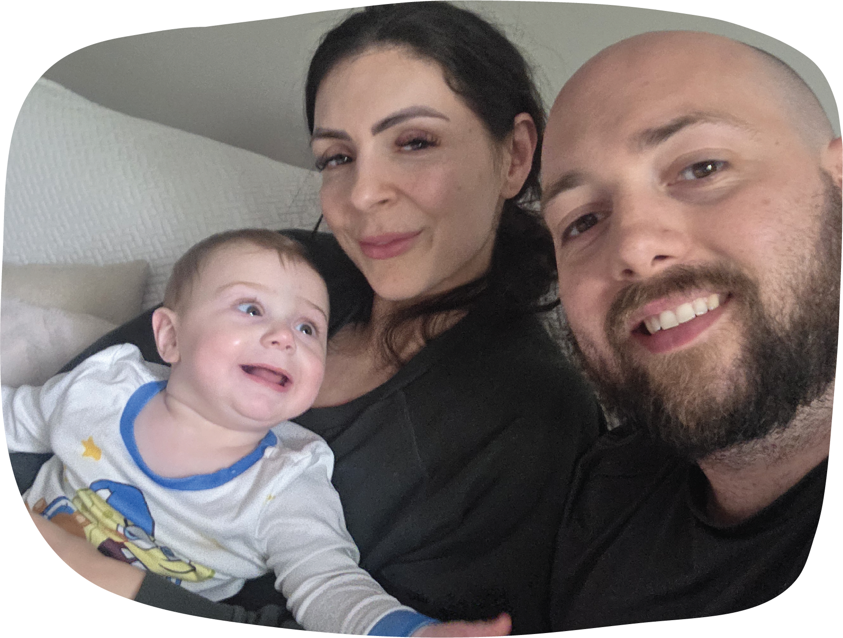 Image of Jordan, his partner, and his son smiling together.