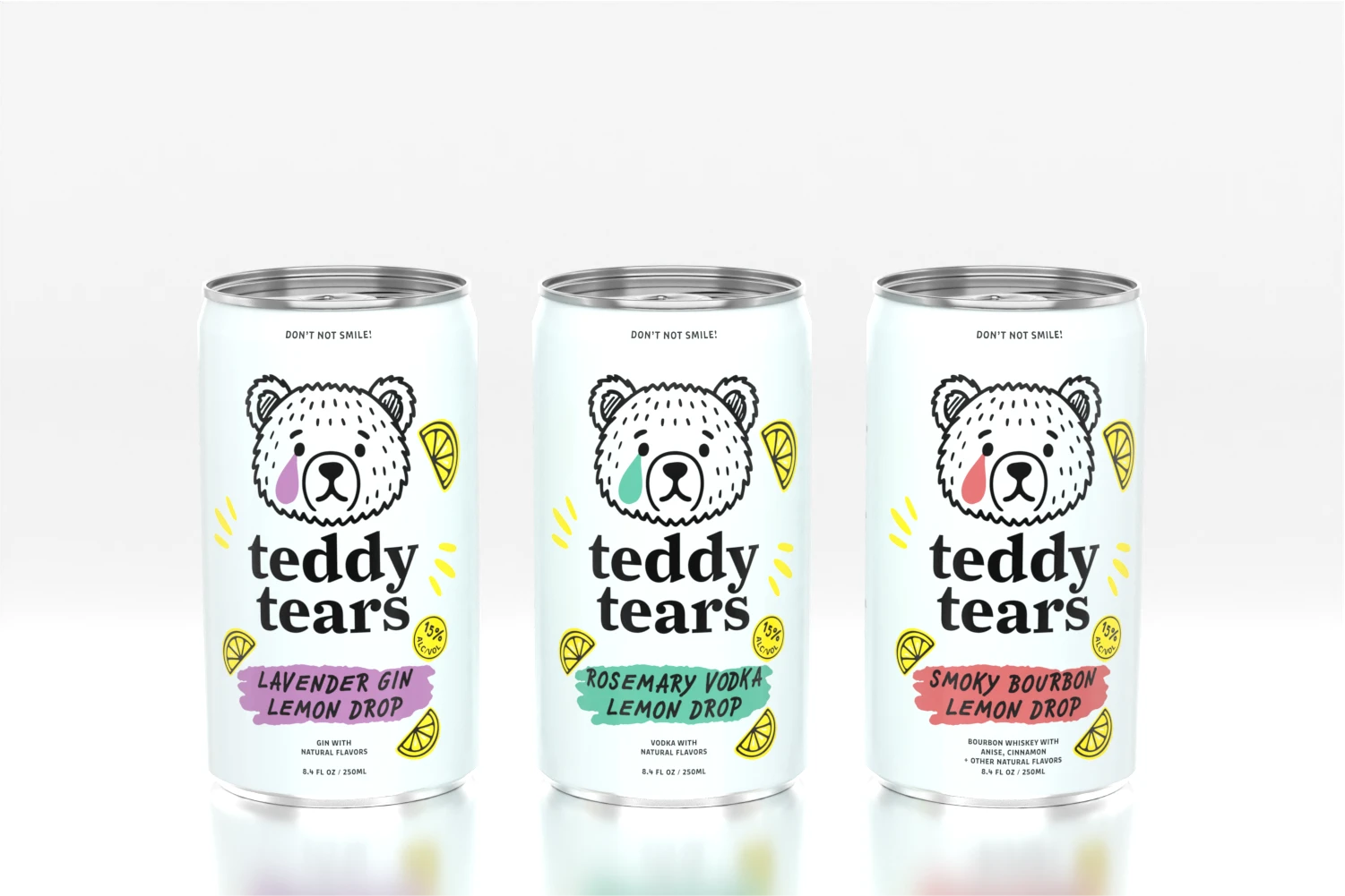 Three Teddy Tears cocktail cans lined up, featuring Lavender Gin Lemon Drop, Rosemary Vodka Lemon Drop, and Smoky Bourbon Lemon Drop flavors with illustrated bear mascot and lemon accents.