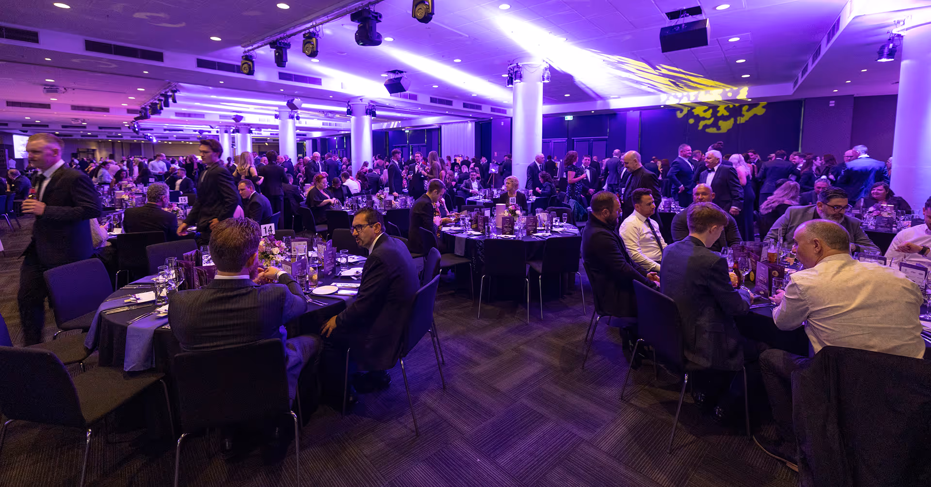 A group of people sitting at tables in a room.