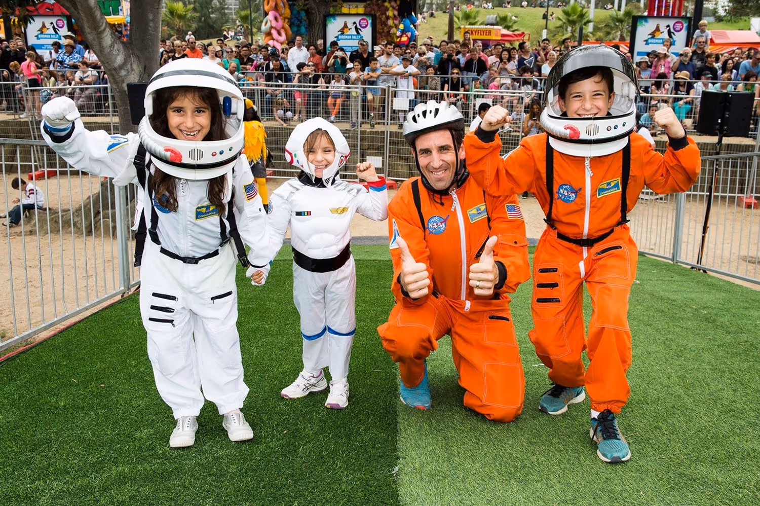 A group of people in space suits posing for a picture.