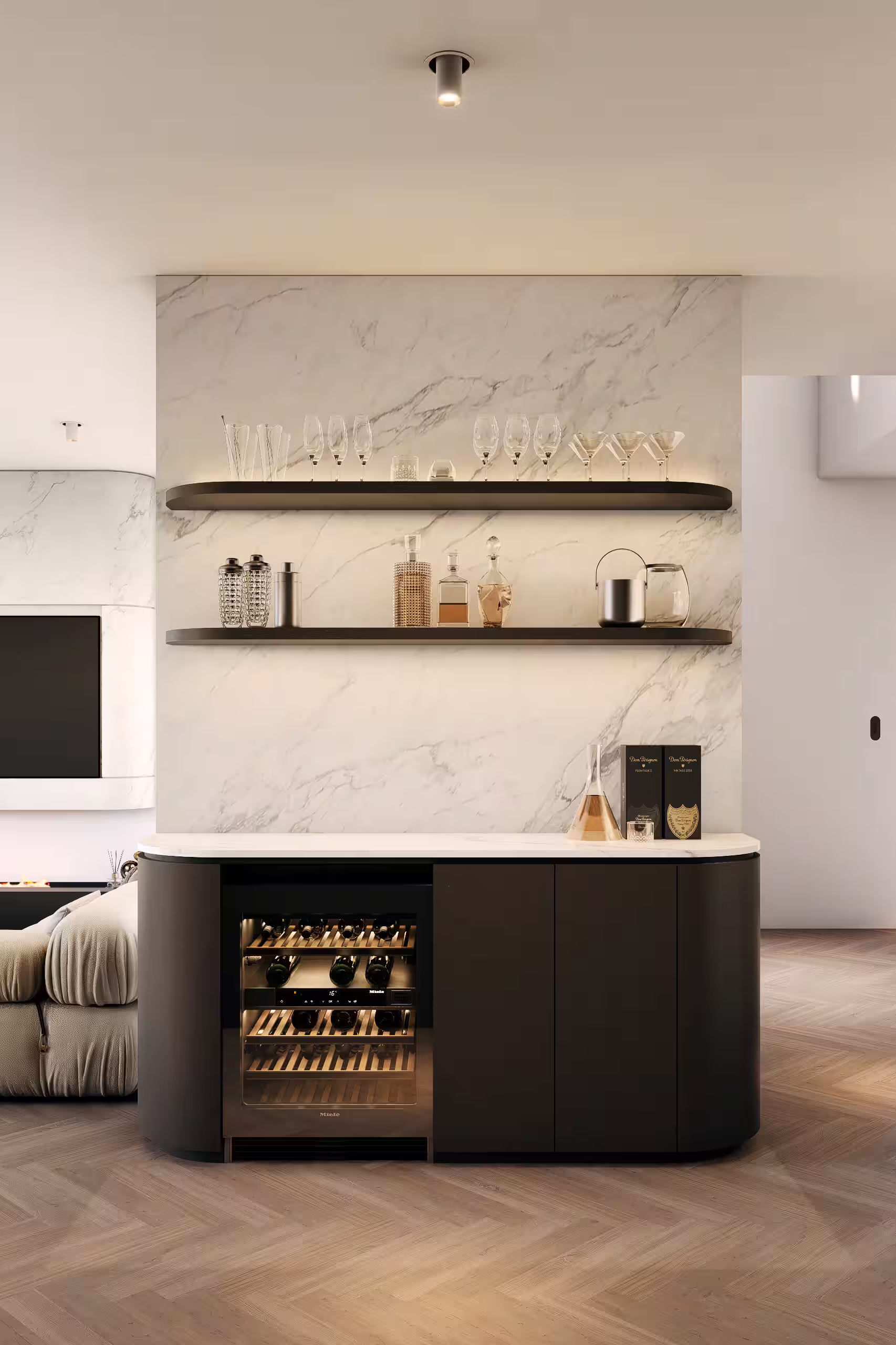 Modern home bar area with marble backsplash, two floating shelves holding glasses and bottles, a wine cooler with bottles, and a smooth countertop with decanters and boxed champagne.