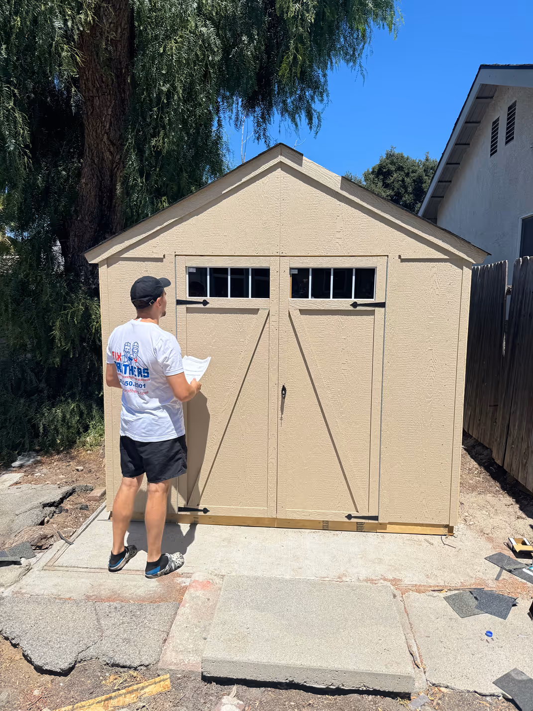 Fix Brothers handyman repairing an exterior garage door and walkway at a Los Angeles home