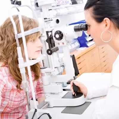 Young patient receiving eye examination with professional ophthalmology equipment