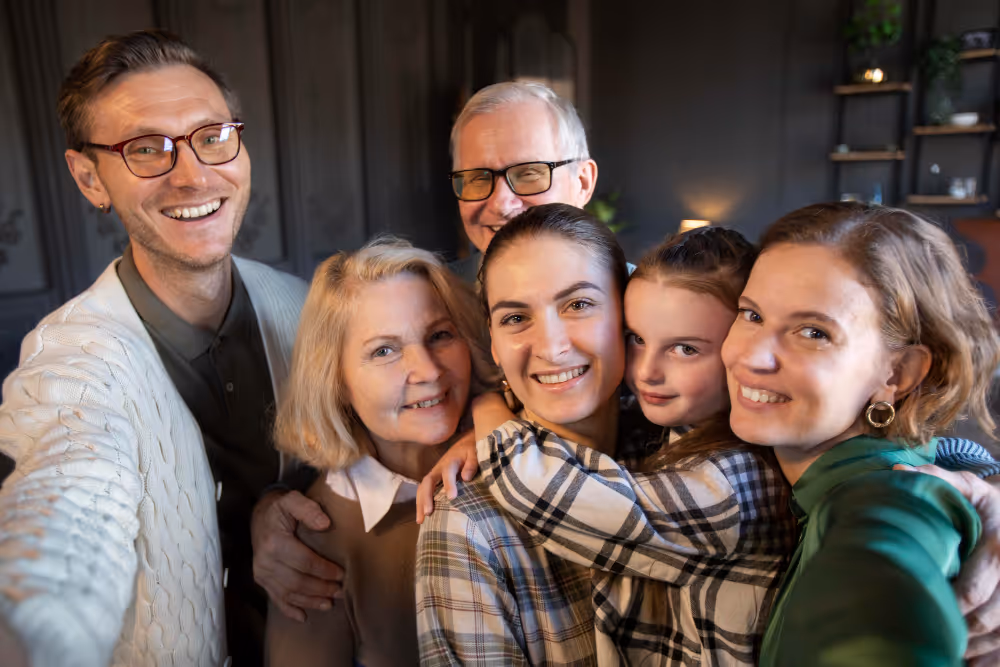 Multigenerational family smiling together in cozy indoor setting