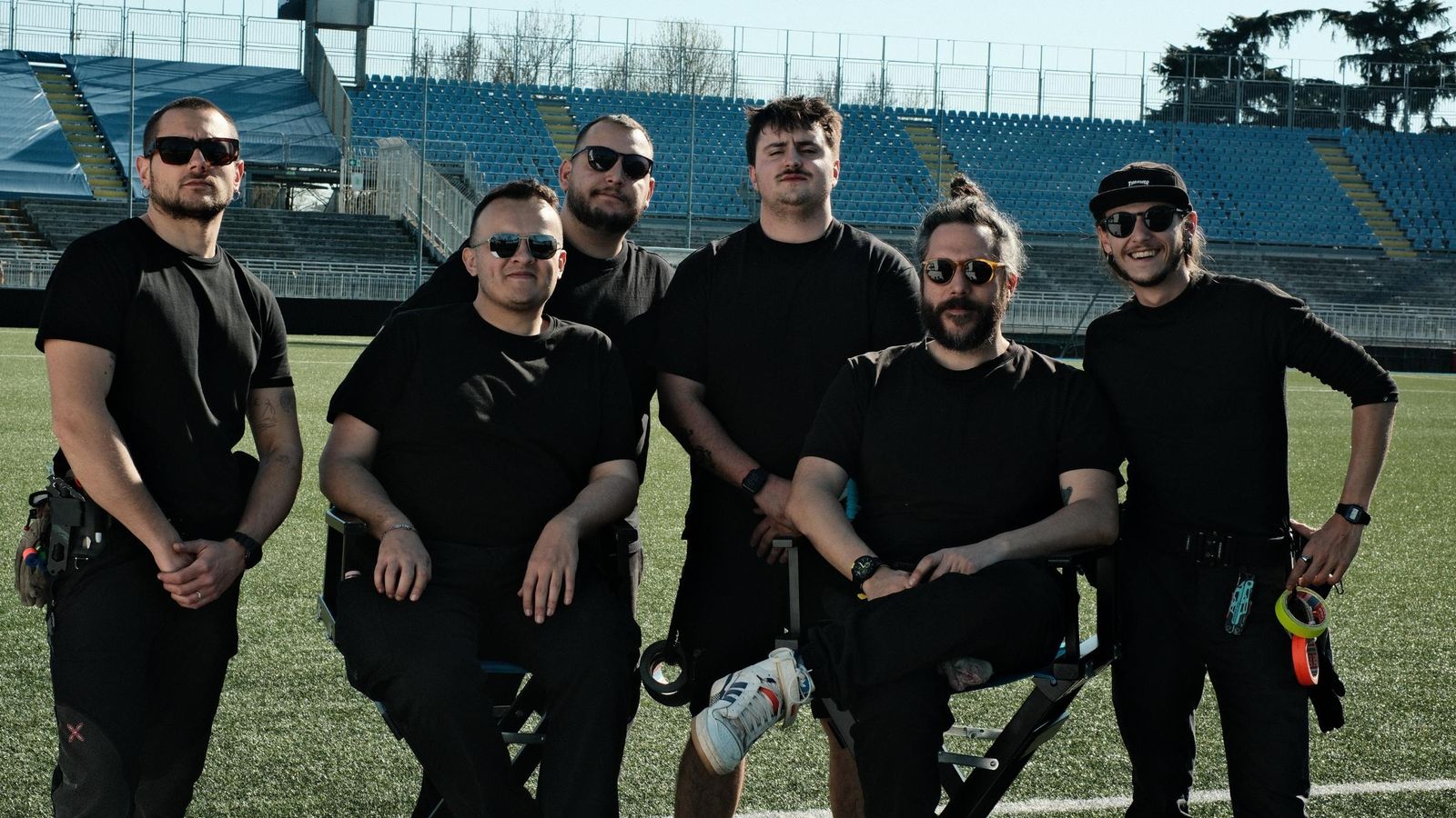 The production crew posing on the pitch at the stadium in Novara