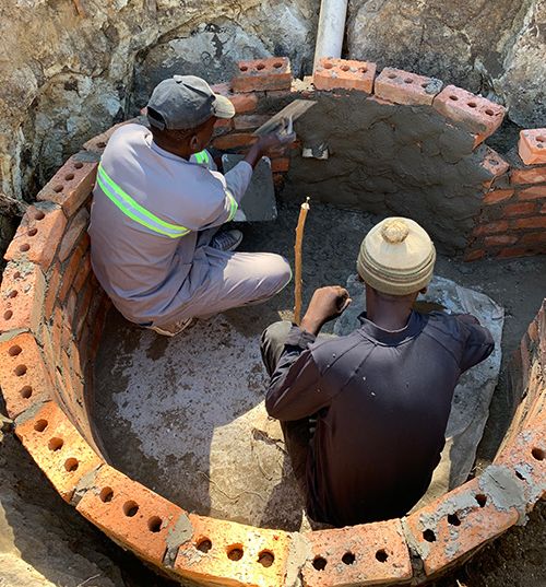 Local workers building a sustainable water tank with the YWAM Perth Appropriate Technology Ministry to provide clean water for their community.