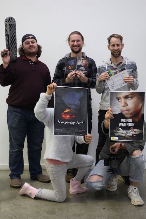Cygnet Films team holding movie posters and production gear, celebrating Christian film projects that share stories of hope.