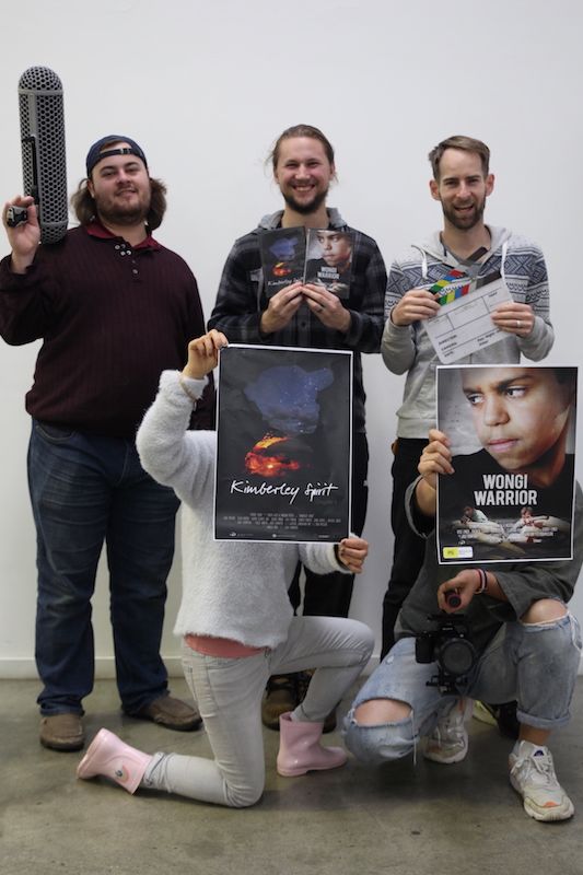 Cygnet Films team holding movie posters and production gear, celebrating Christian film projects that share stories of hope.