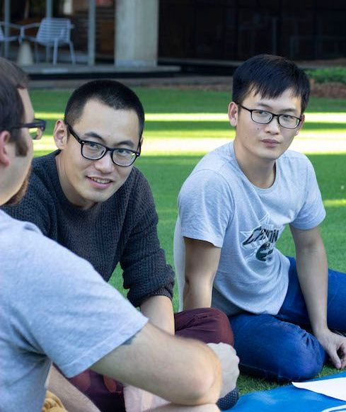 Frontiers team member building friendship through conversation with international students on a university lawn.