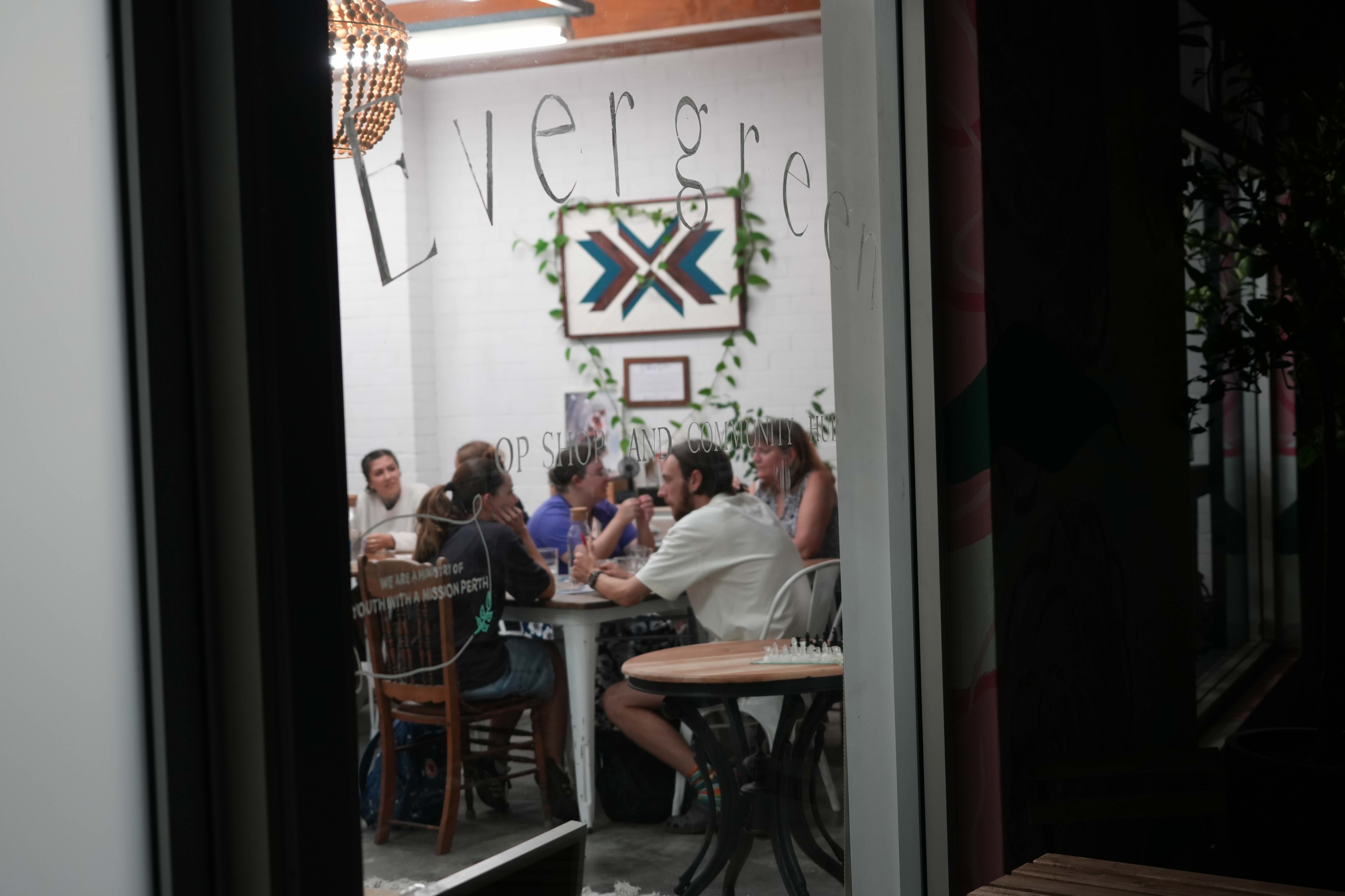 people chat inside a cafe at night