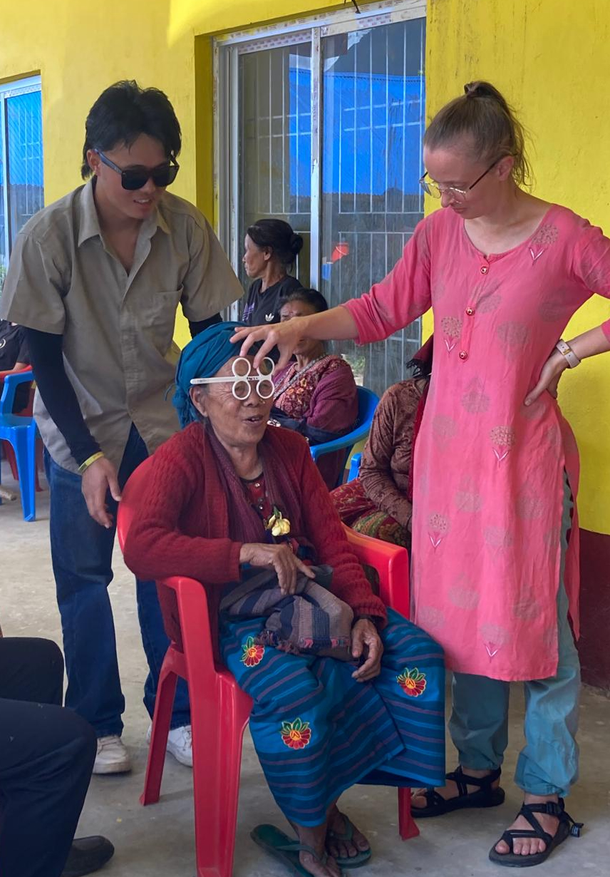 a health care worker checks a lady's vision 