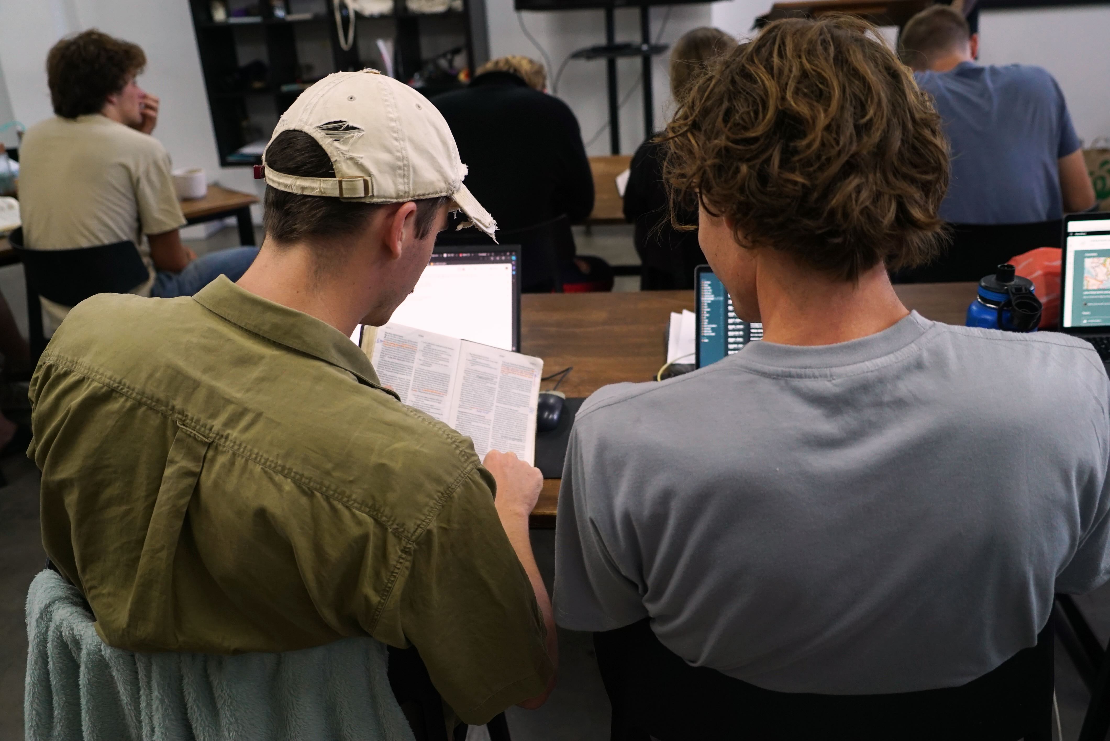 two young men study the Bible 
