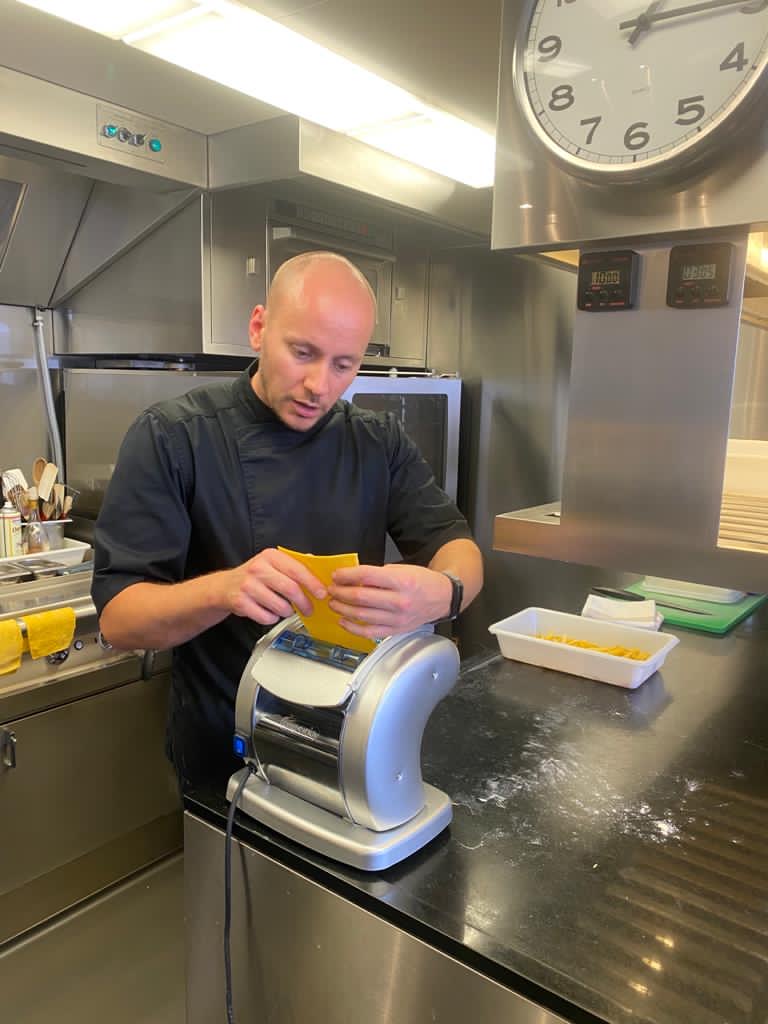 Chris Demaillet, founder of Montclair Chef, demonstrating his pastry skills by handcrafting croissants in a professional kitchen.