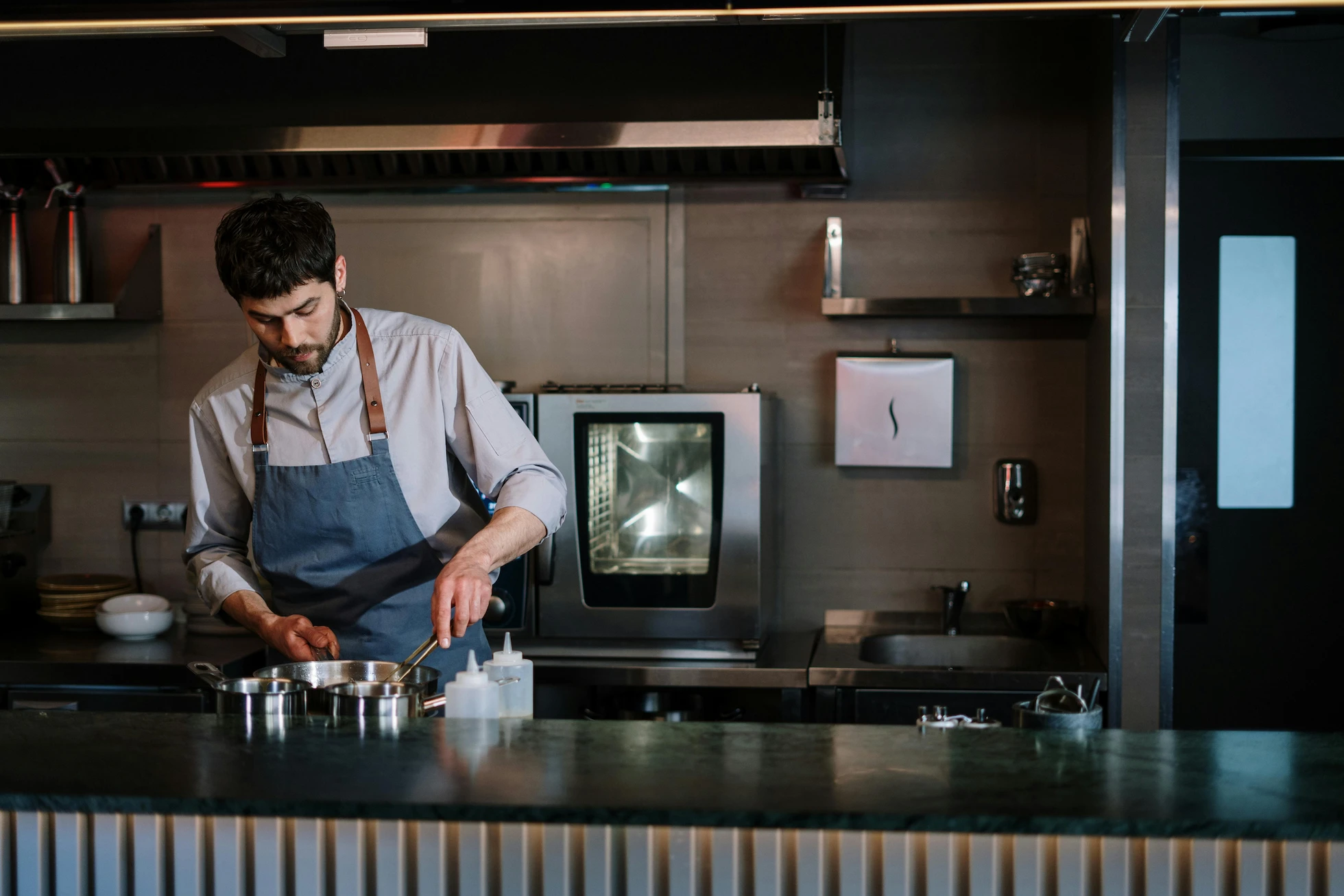 Private chef cooking in a modern luxury kitchen, focused on preparation and precision