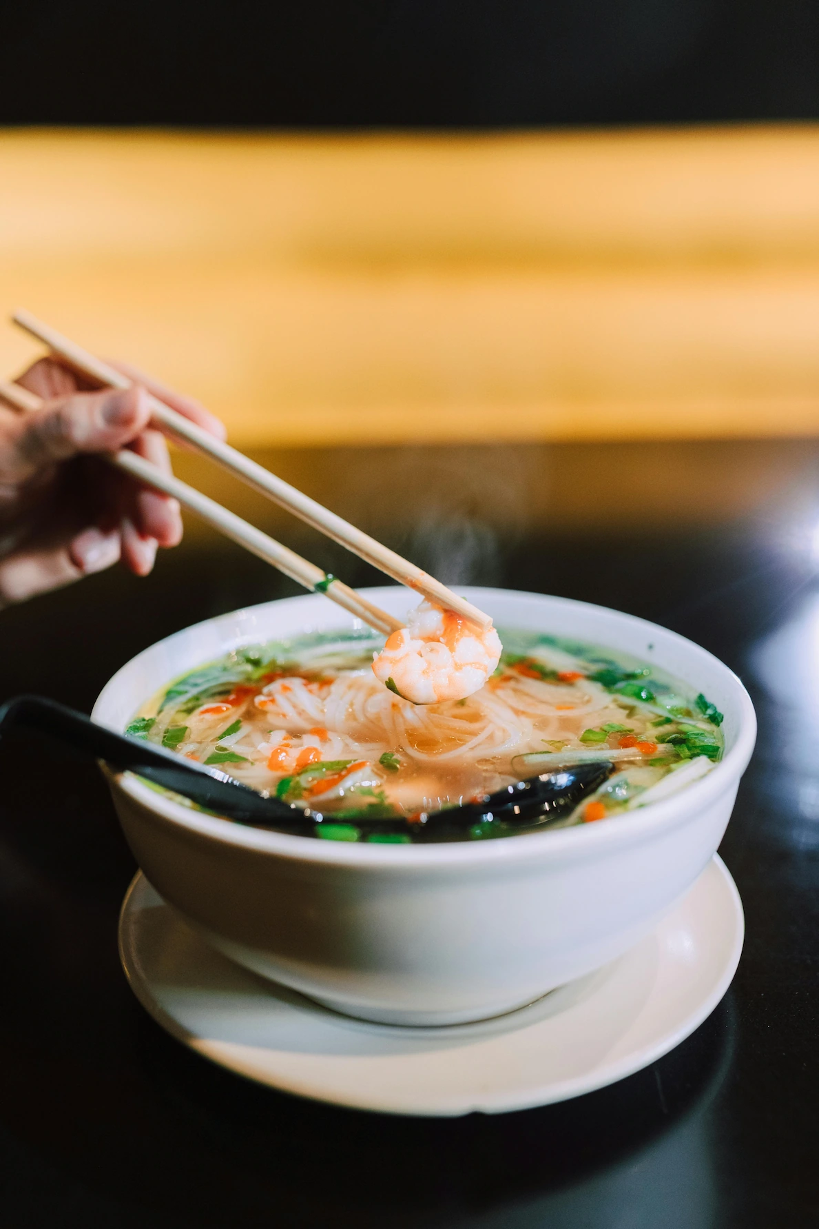Authentic Asian noodle soup with shrimp and vegetables, prepared by a specialized private chef.