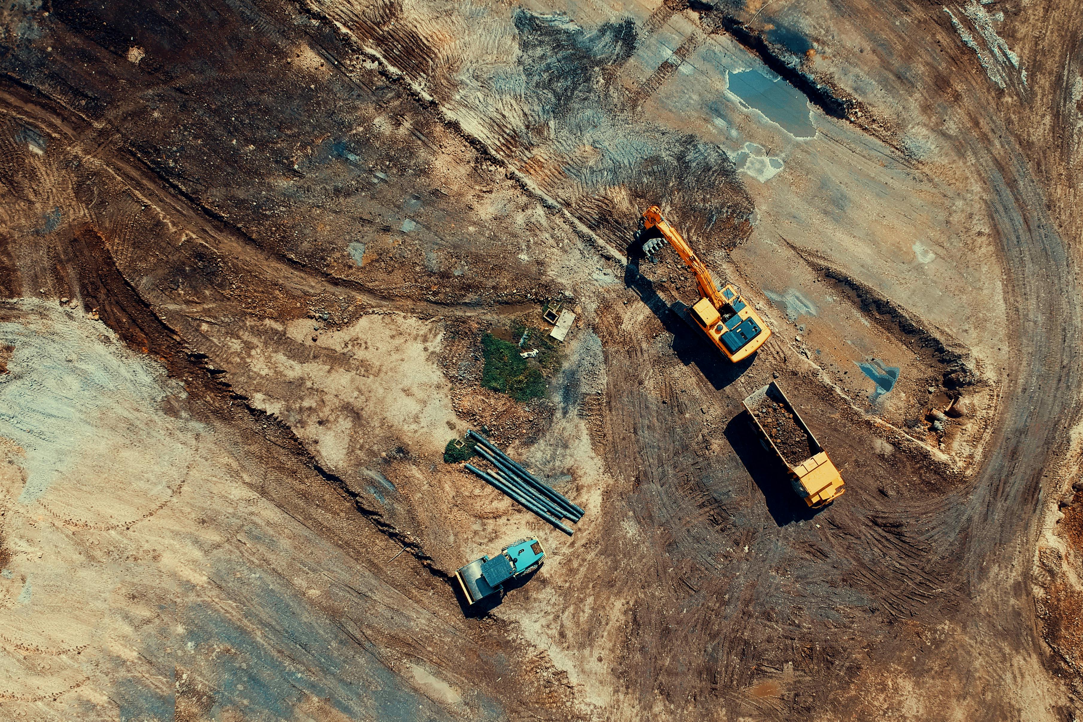 Mining drill rig on-site equipped with drill rods and consumables.