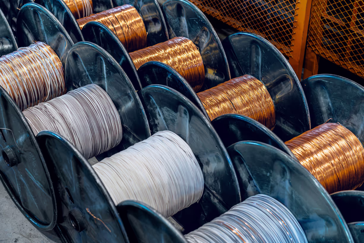 Freshly manufactured cables are laying on the floor in spools