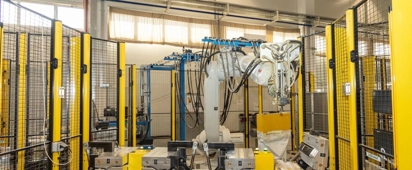 A large multi-axisd robot sits in a manufacturing plant