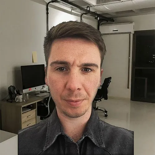 A prevent group employee is standing in his office for a portrait photo