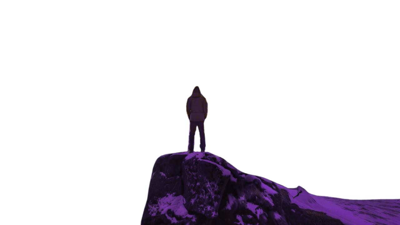 A photo of  some snowy mountains and the aurora borealis. A man stands in the foreground, on the edge of a small peak. The whole photo has a green haze to it, with those colours being predominant in the aurora borealis