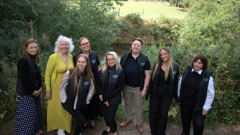 A photo of the Angel Accounting Team stood around a tree smiling just outside of their office based in Alcester, Warwickshire. They are all smiling to the camera, to prove their welcoming value when completing accounts for businesses.