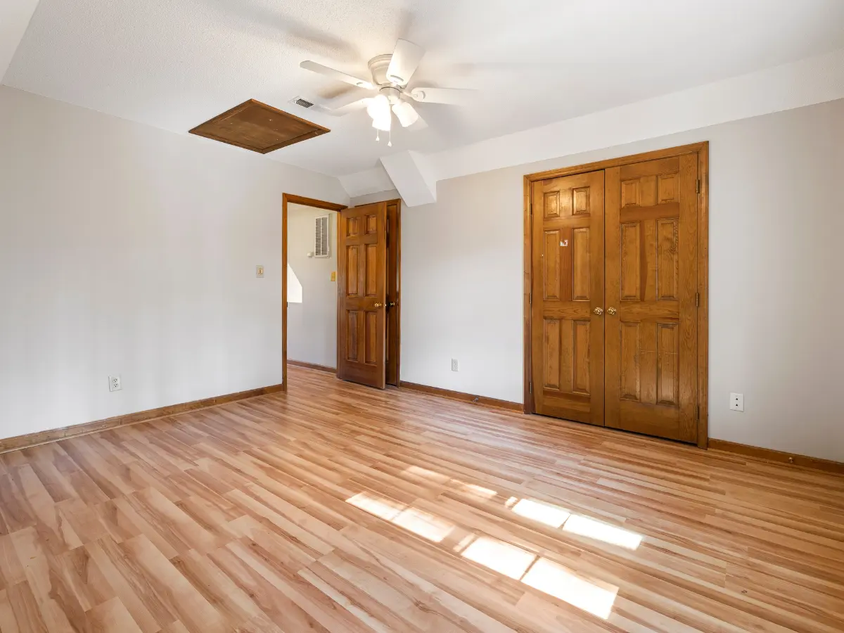 A cozy room featuring hardwood floors and a ceiling fan, creating a warm and inviting atmosphere, image