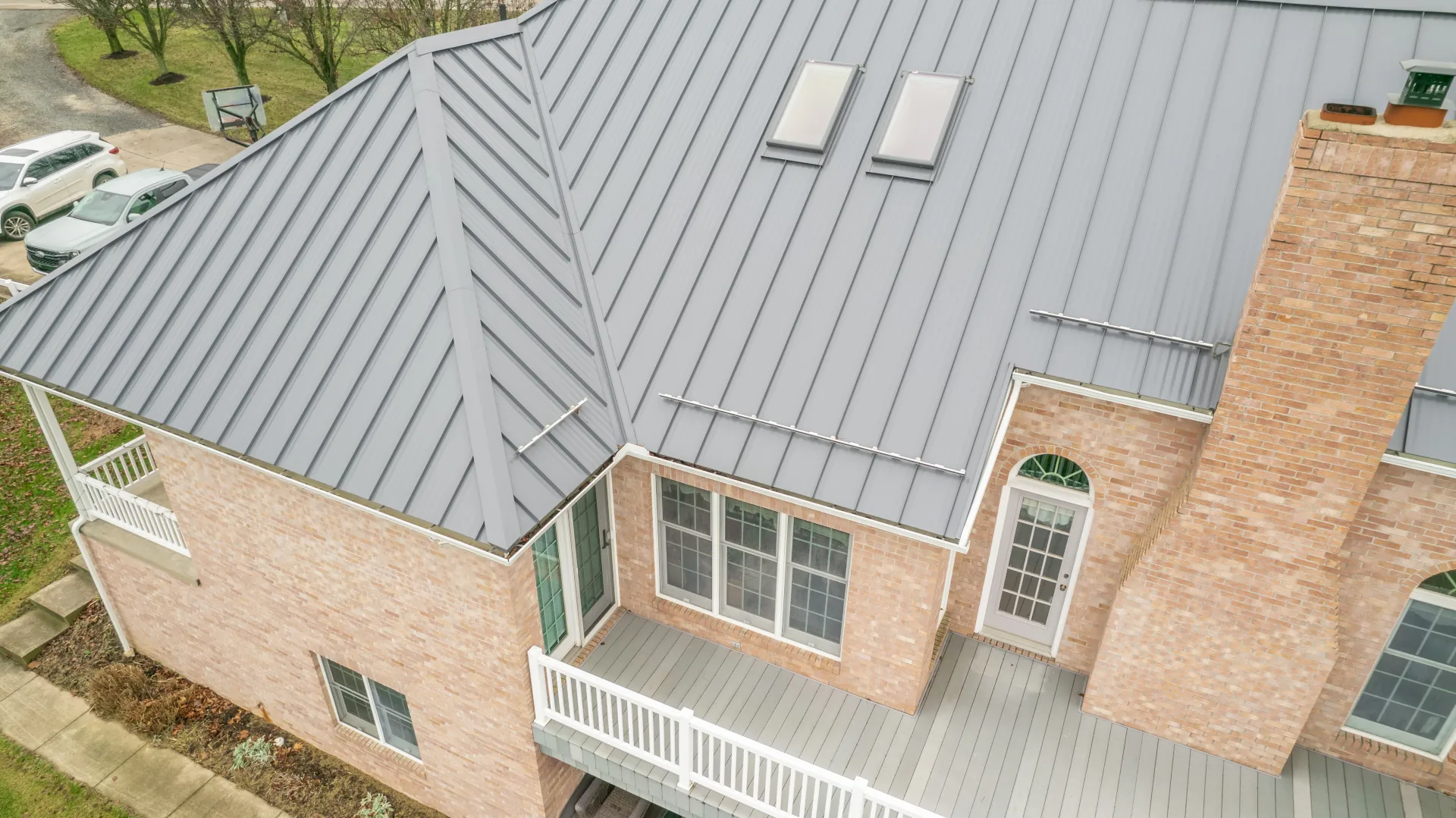 2-story brick house with metal roofing and snow guards