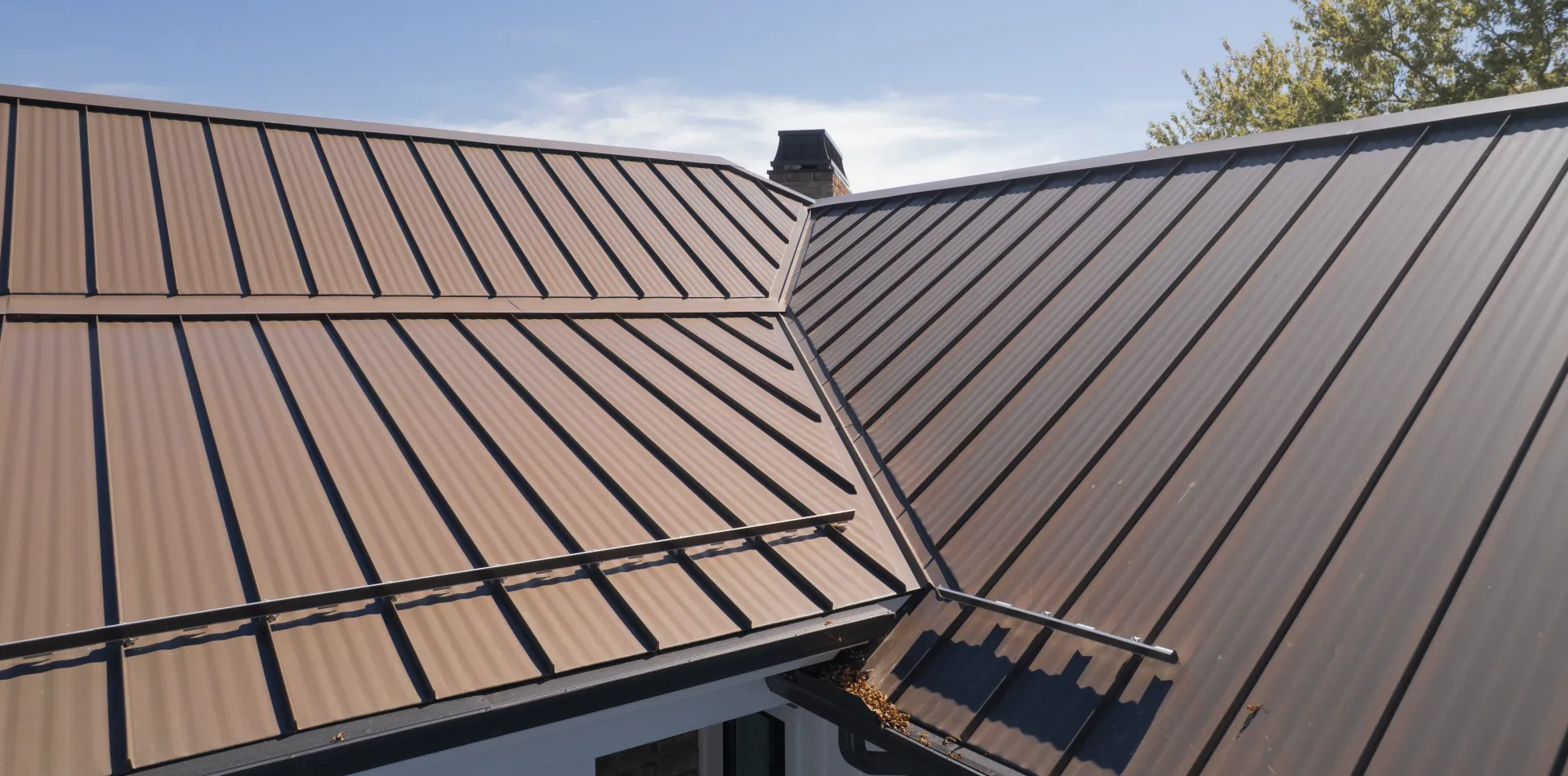 brown metal roof with snow guards and gutter guards