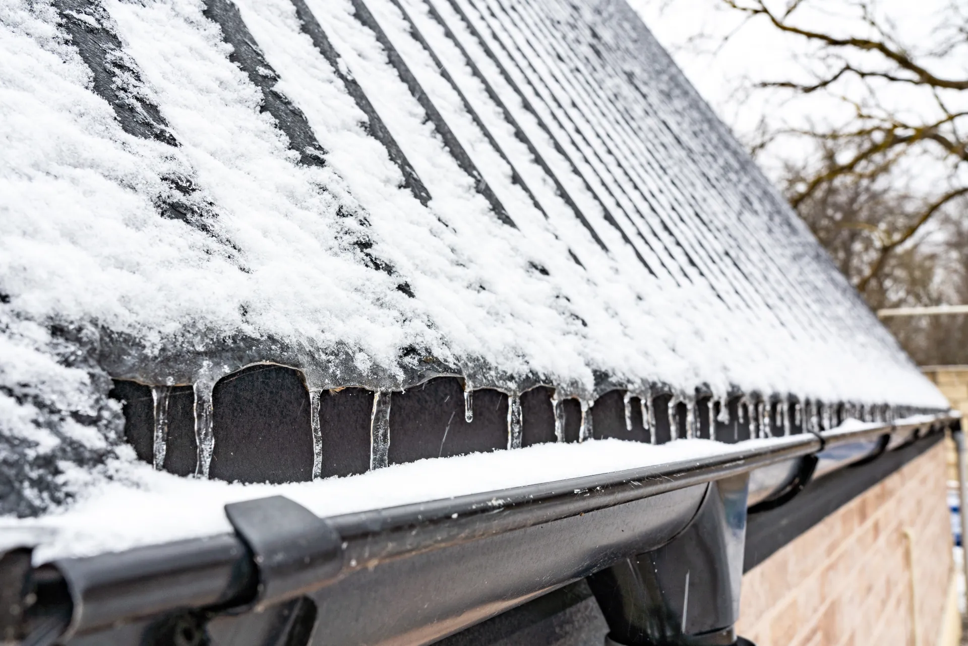 metal roof and gutters covered in snow and ice