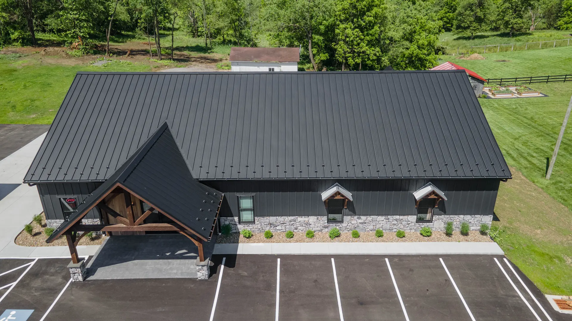 local business with black metal roofing in the summer