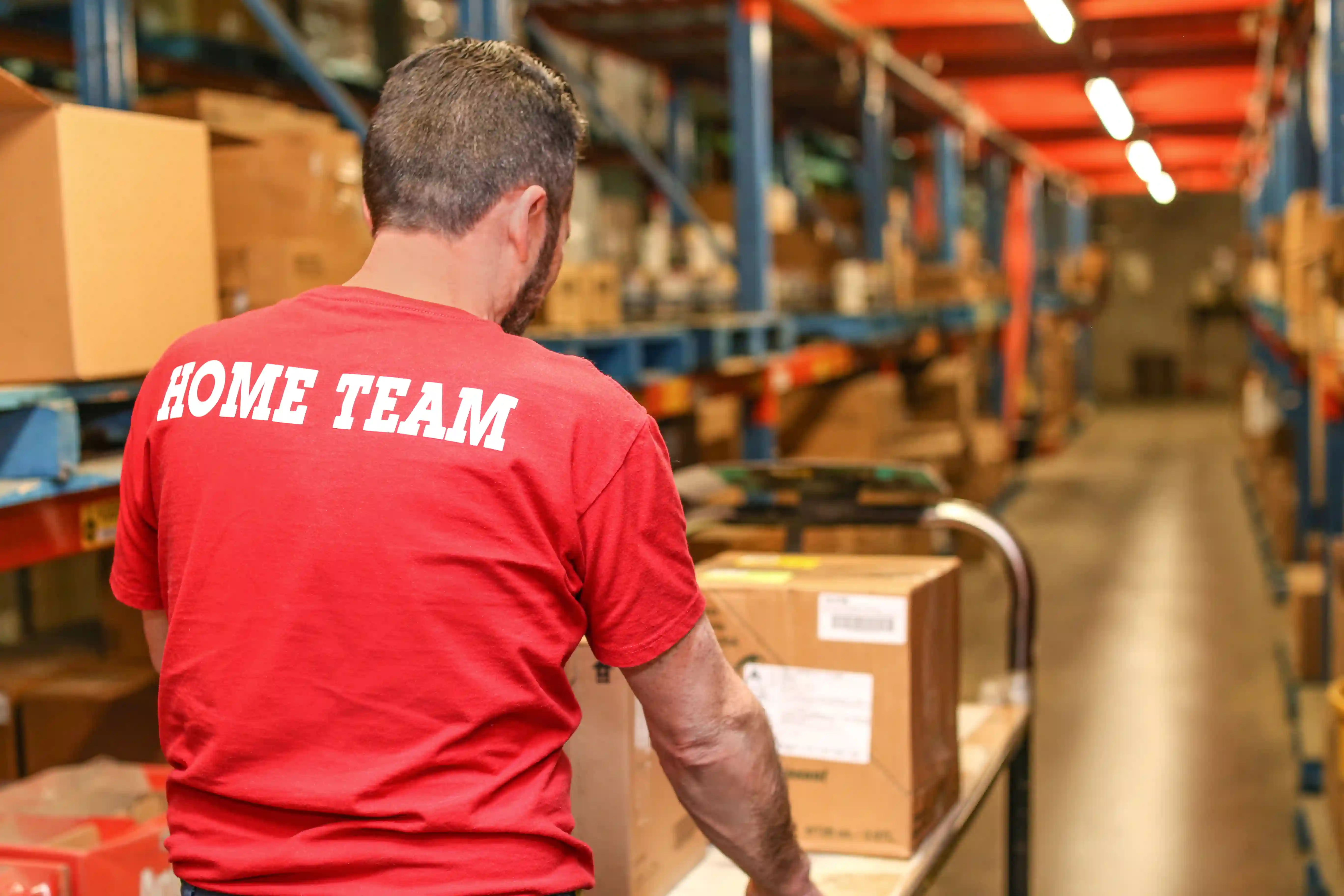 Heinen Group Home Hardware employee pushing a cart full of boxes
