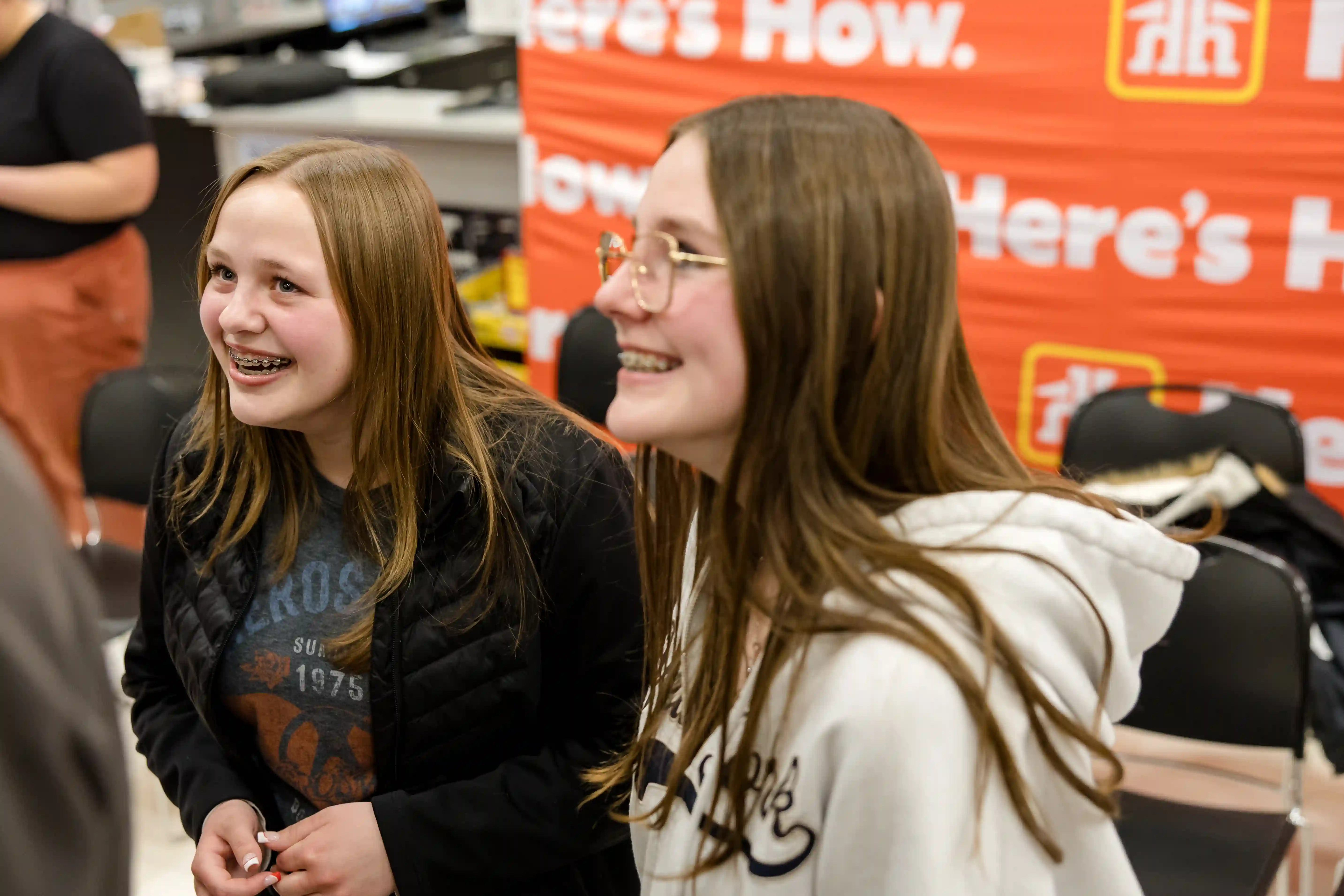 Two young females smiling