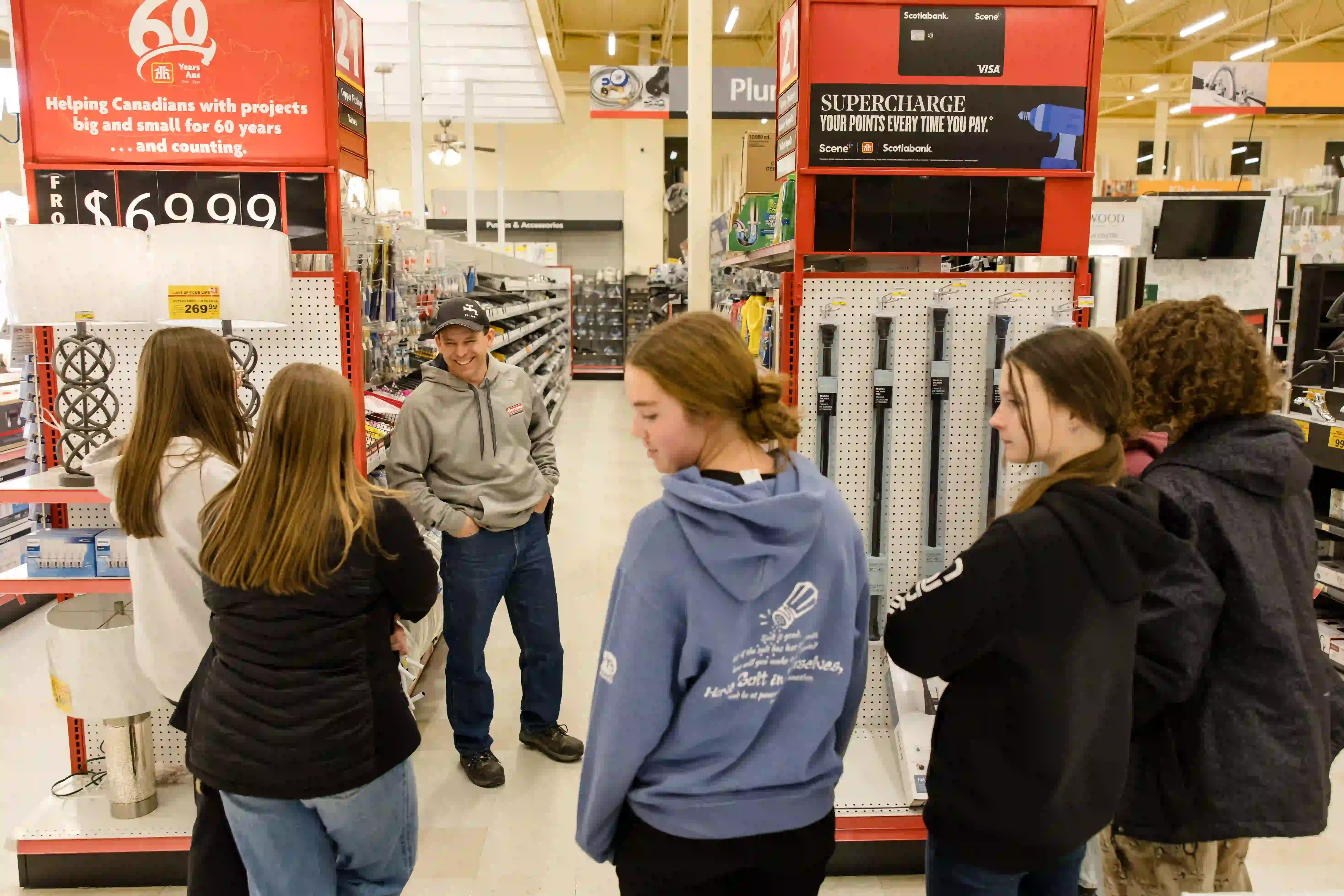 Group of young people in front of plumbing aisle