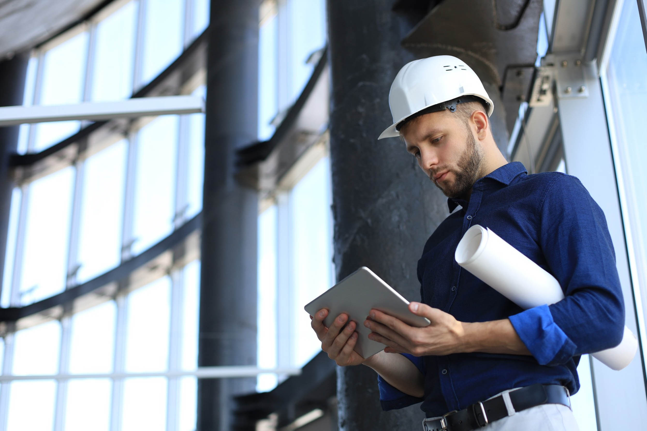 A construction worker on a tablet.
