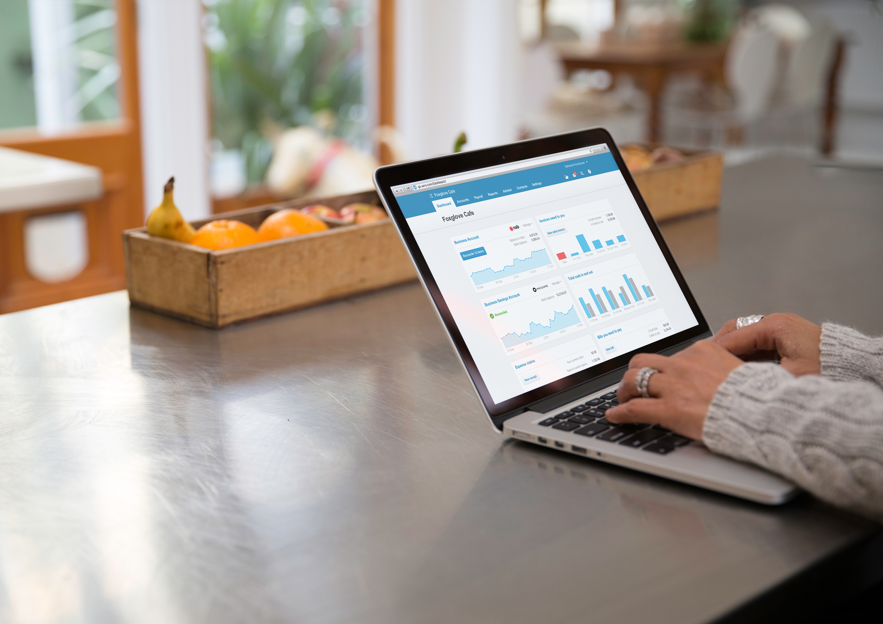 Xero online cloud accounting app being used on a laptop in someone's kitchen.