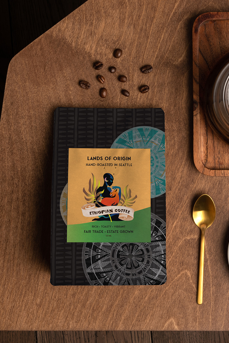 Bag of Ethiopian coffee with artistic label, coffee beans, golden spoon, and wooden surface.