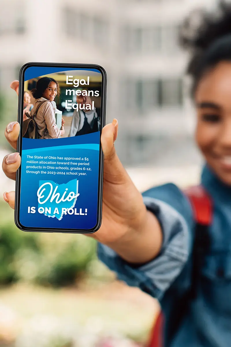 Woman holding phone showing Egal Pads on a Roll Social media. Gryphon Design Strategy created the EGAL brand identity, responsive website, and digital communications platform to advance menstrual health equity through accessible education, consumer engagement, and awareness for Pads on a Roll.