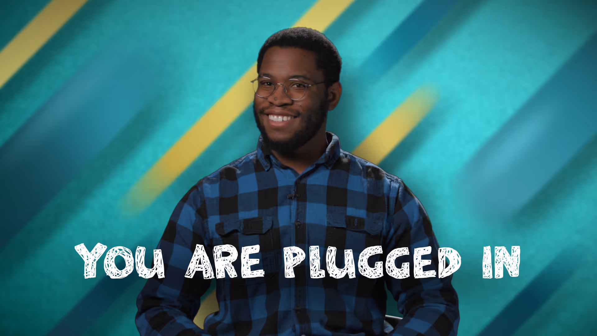 Video thumbnail of a man. Text below him reads: YOU ARE PLUGGED IN.