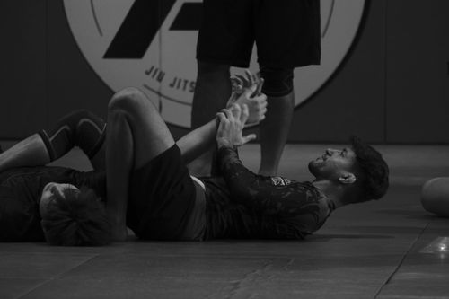 Professor Livio demonstrating armbar at Ares Peoria Jiu Jitsu Academy