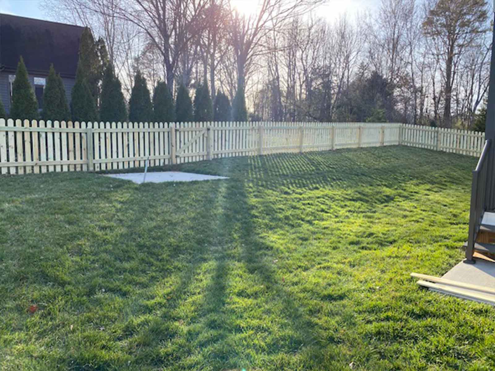 Dog ear wood picket fence showing the finished side facing outward