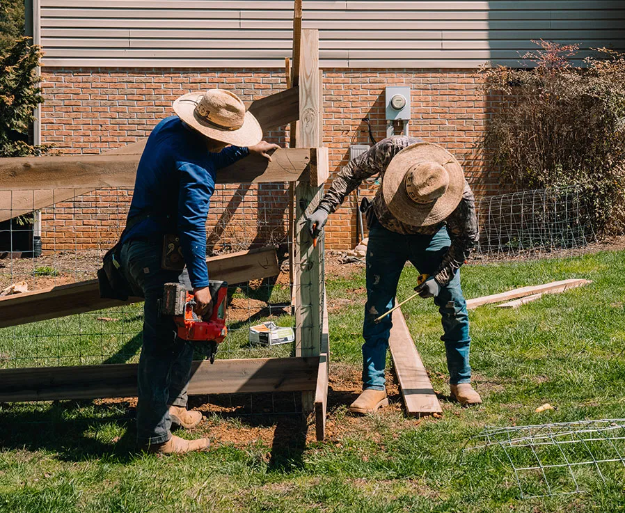 Loudon County Fence crew setting fence posts on a job site in East Tennessee