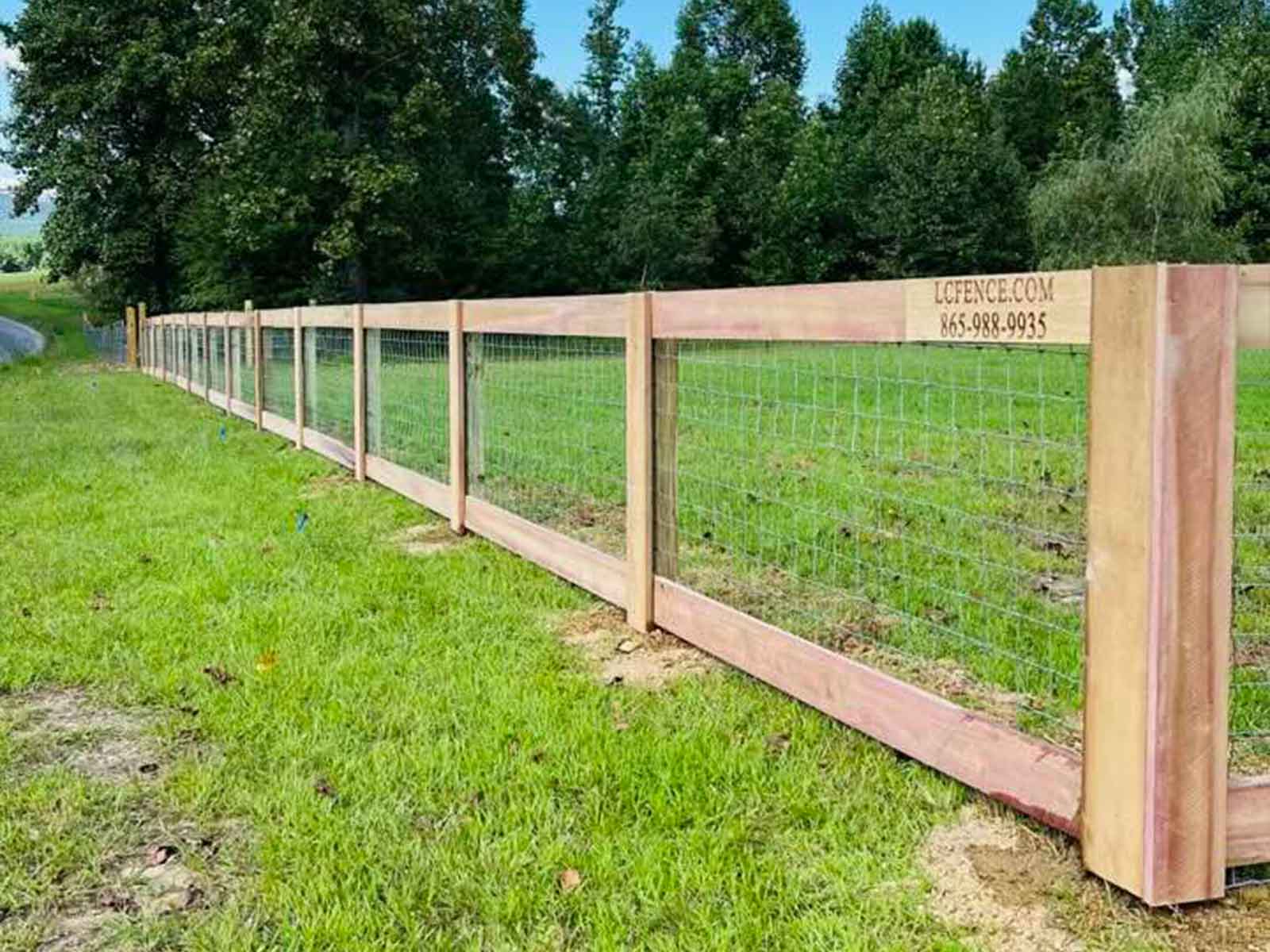 Two board farm fence set in East Tennessee red clay soil