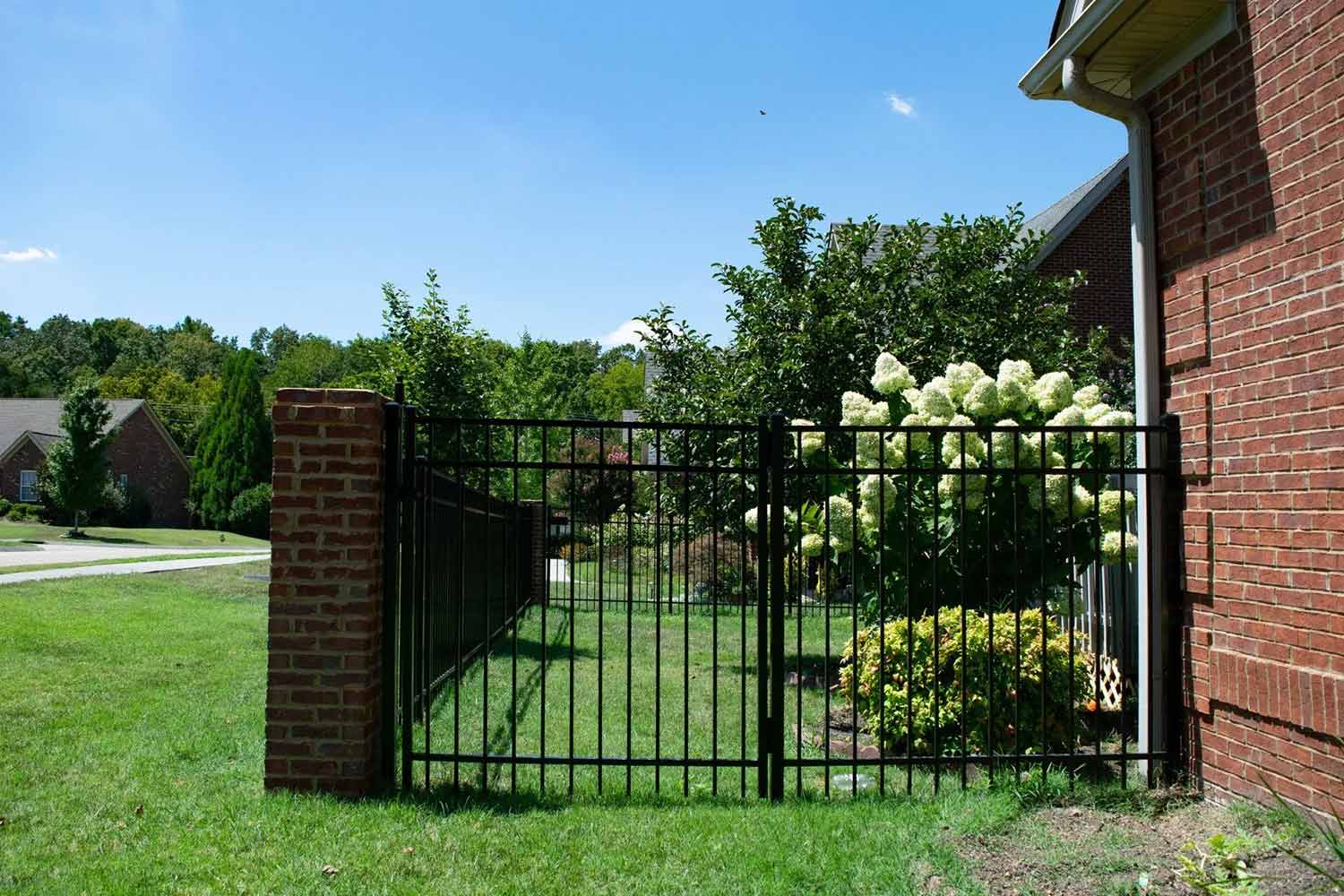 Black ornamental aluminum fence with sightlines preserved at a corner