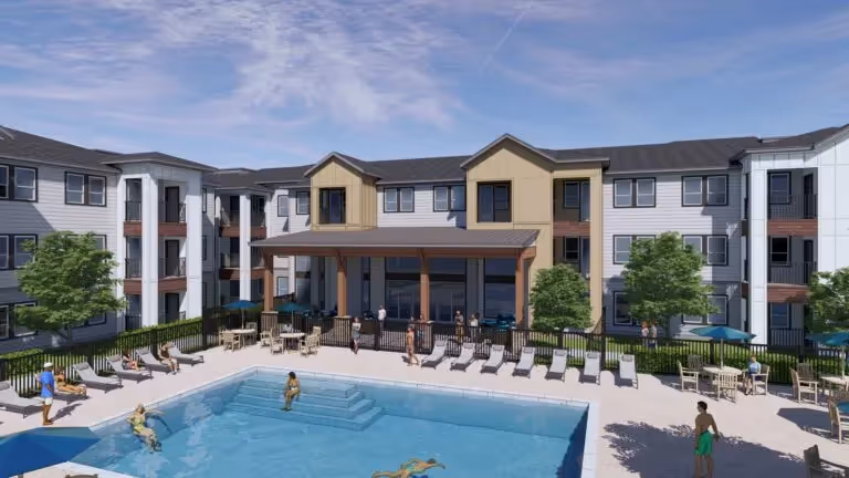 Resort-style swimming pool and sundeck with lounge chairs, featuring a covered outdoor lounge area and the modern apartment buildings in the background at Red Oaks in Austin, TX.